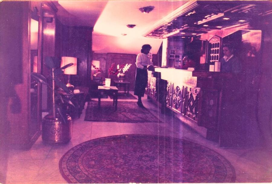 Archive photograph of Mervat behind the hotel's reception desk