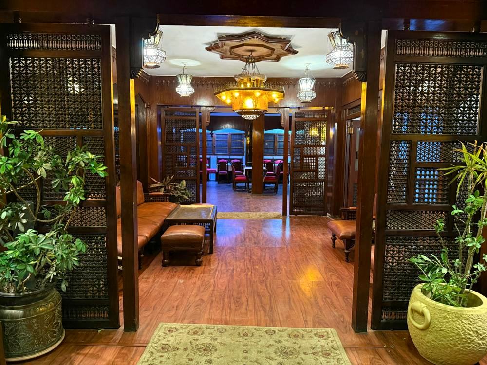 The lounge doors today, mashrabiya panels restored, with plants either side